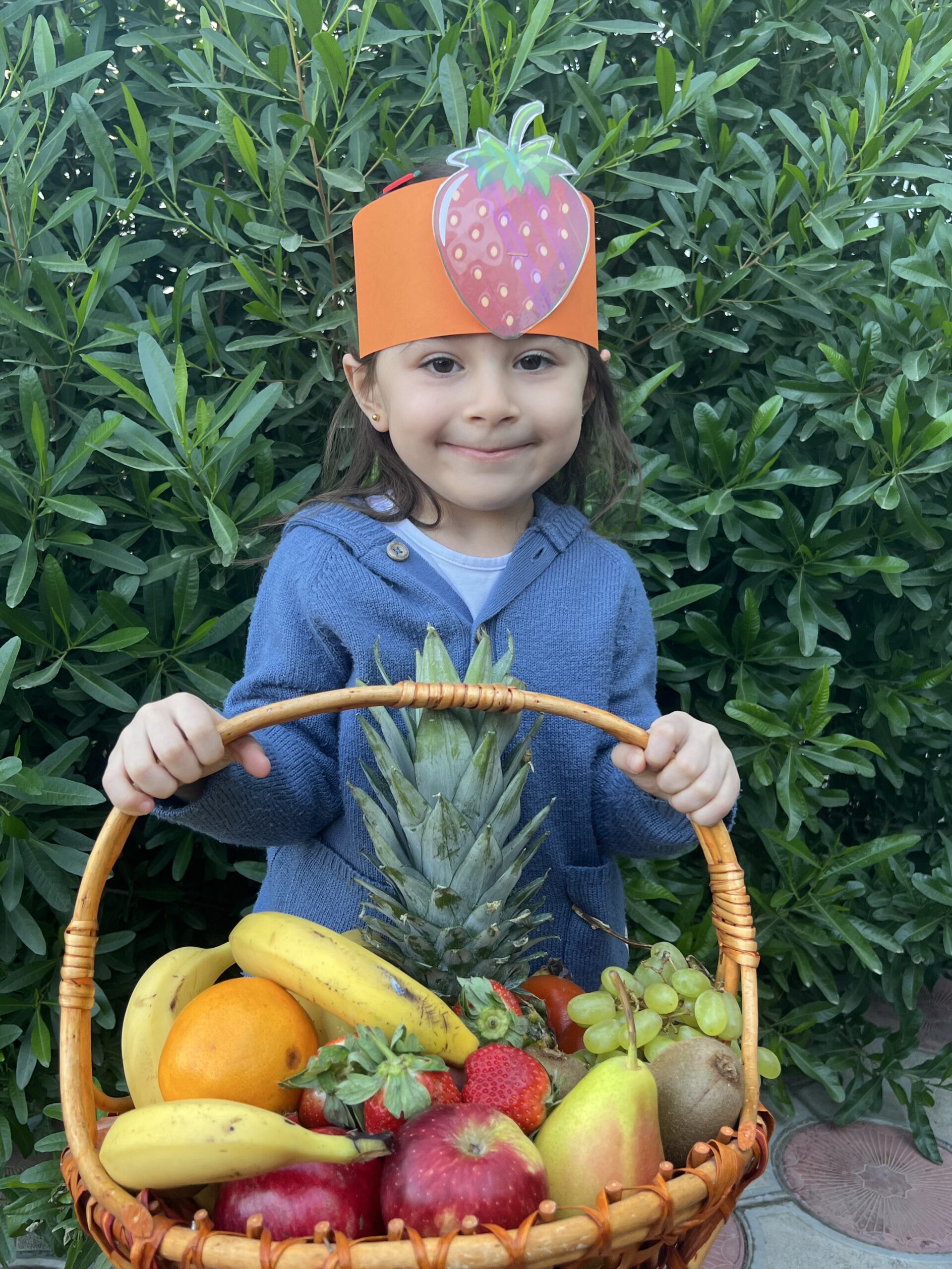 a child holding a basket of fruit, Sanny Private Kindergarten Erbil activities