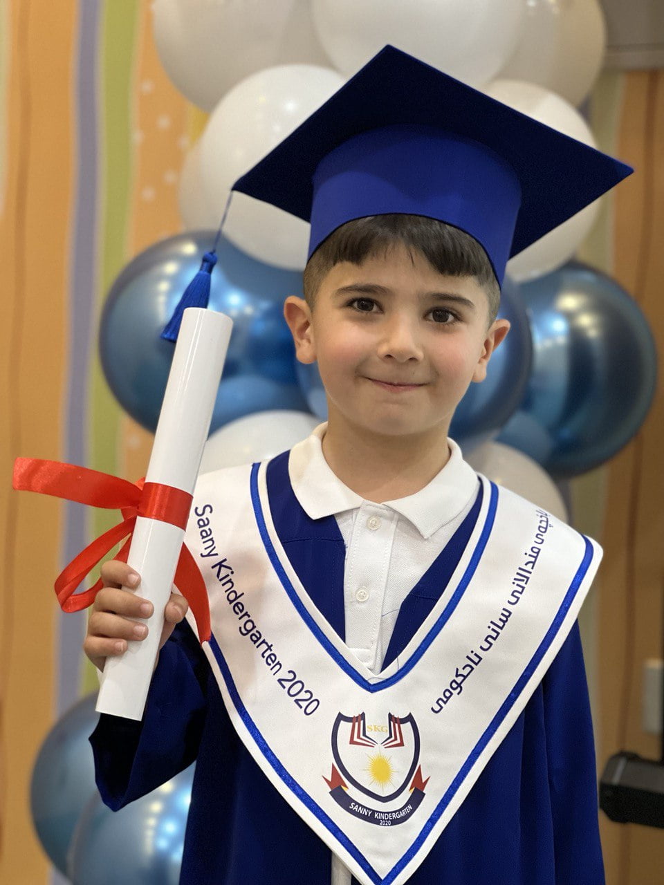 young boy, graduation gown